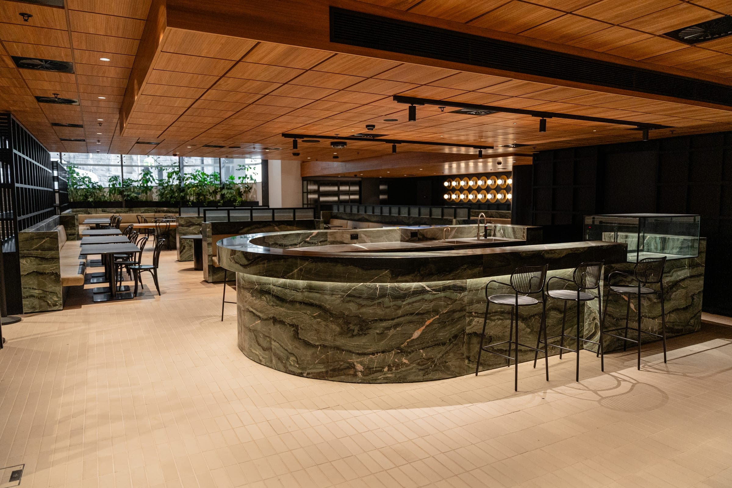 A curved stone bar front and servery